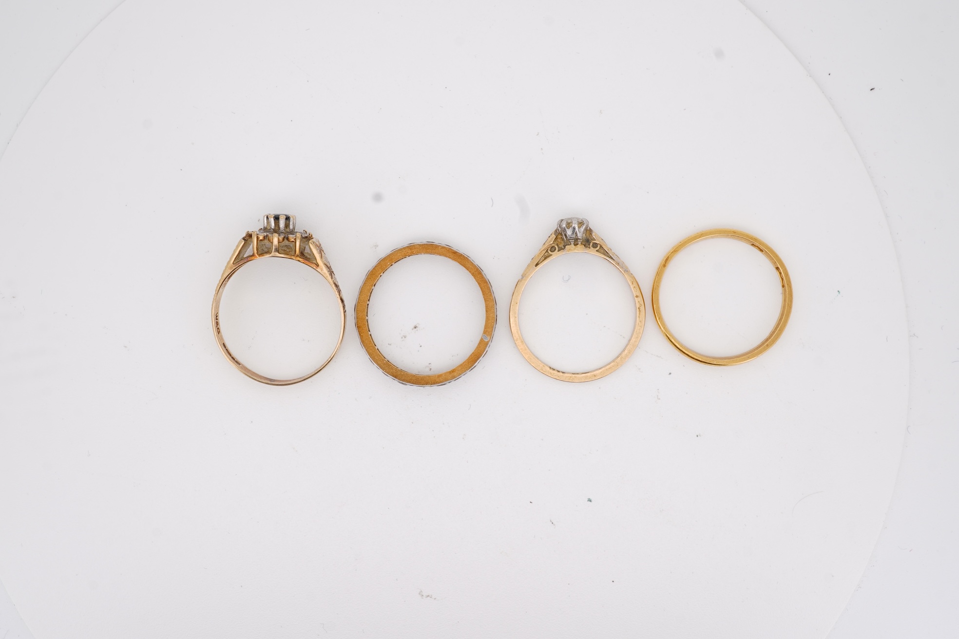 A 22ct wedding band, size M, 2 grams, an 18ct, plat and single stone diamond ring, a a modern 9ct gold, sapphire and diamond cluster ring and a yellow metal and white stone, eternity ring.